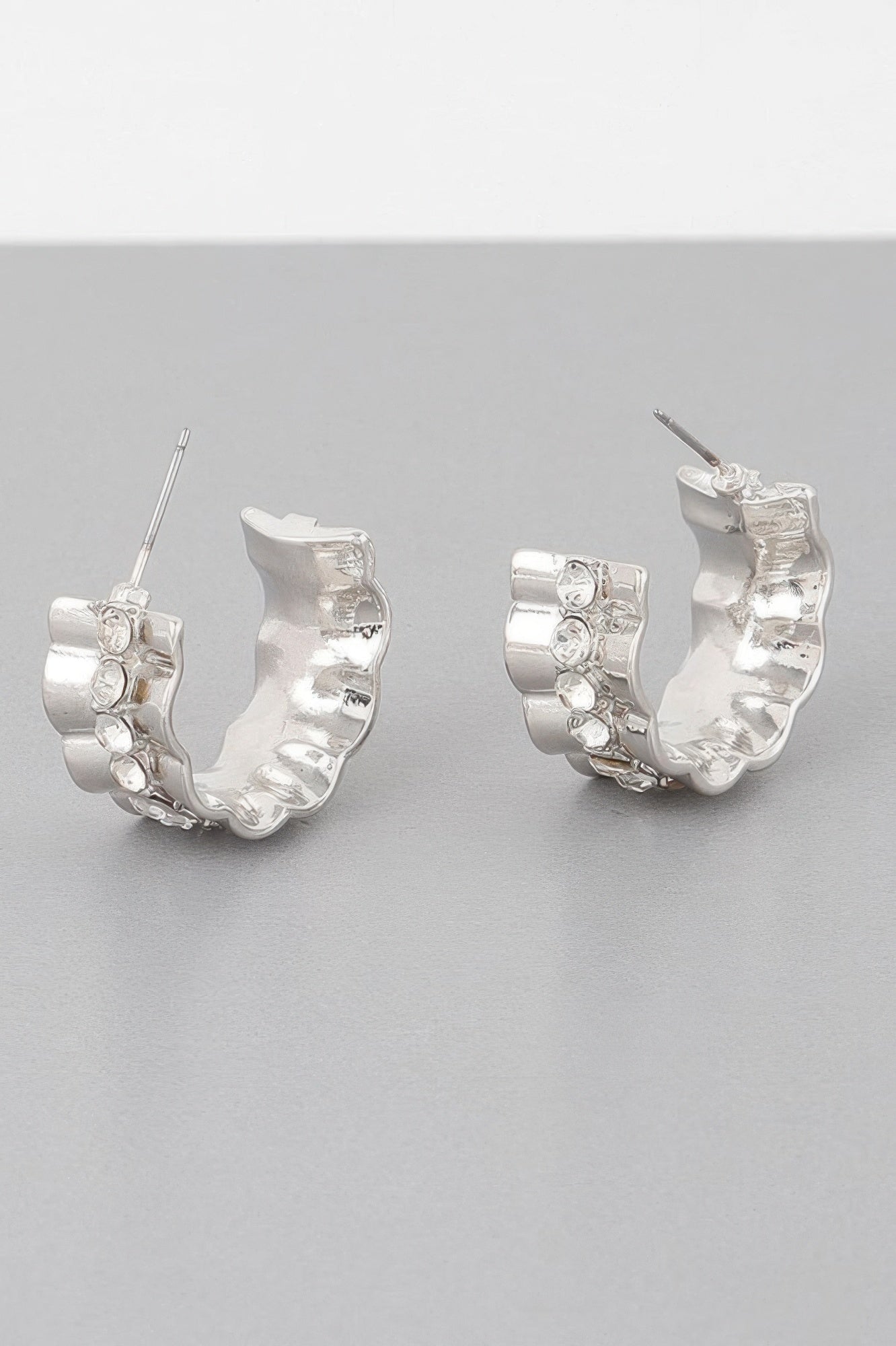 Jeweled lace hoop earrings in silver tone with clear round stones