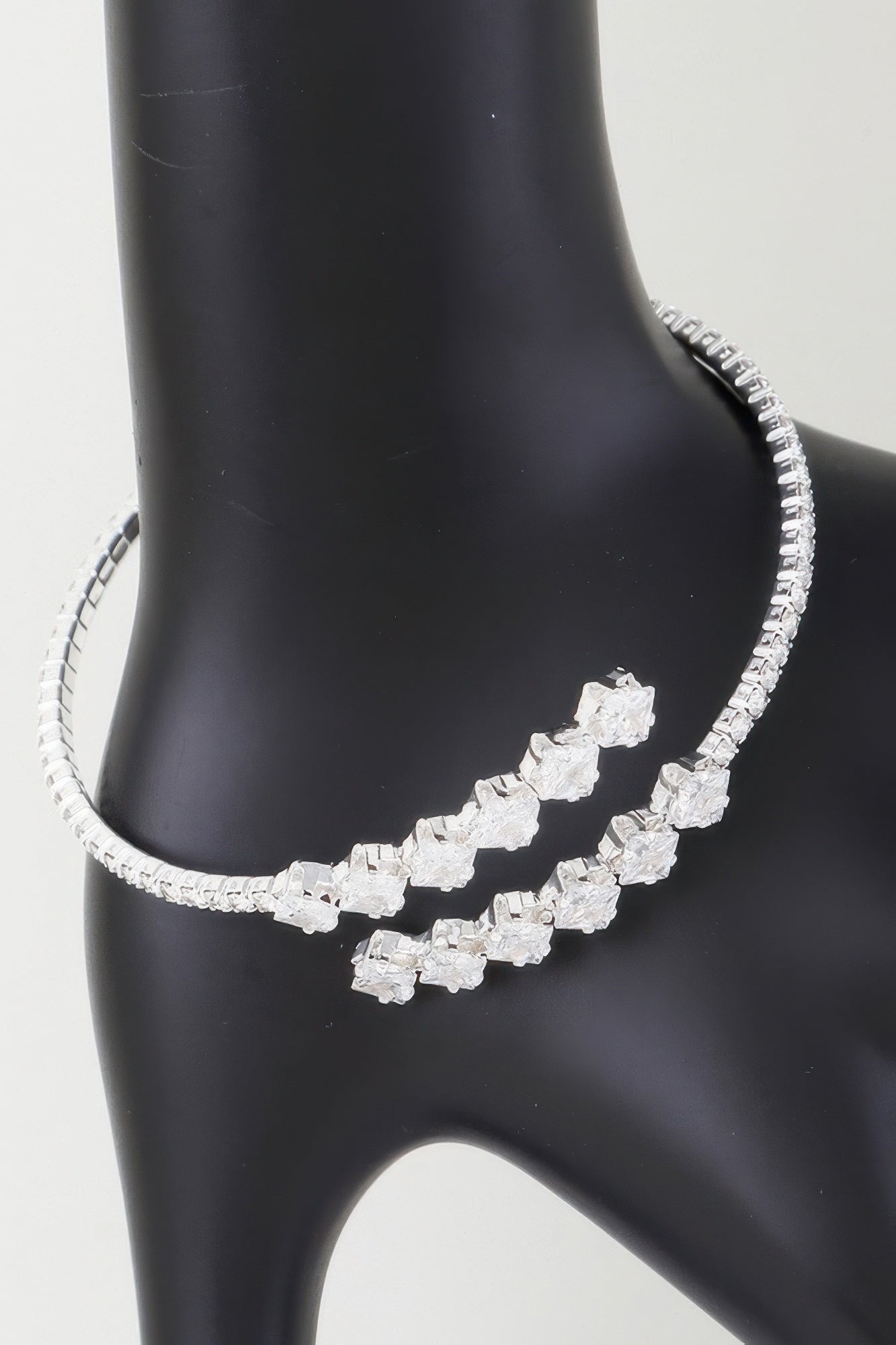 Silver clear jeweled star wrap bracelet with two diamond-studded rows on form