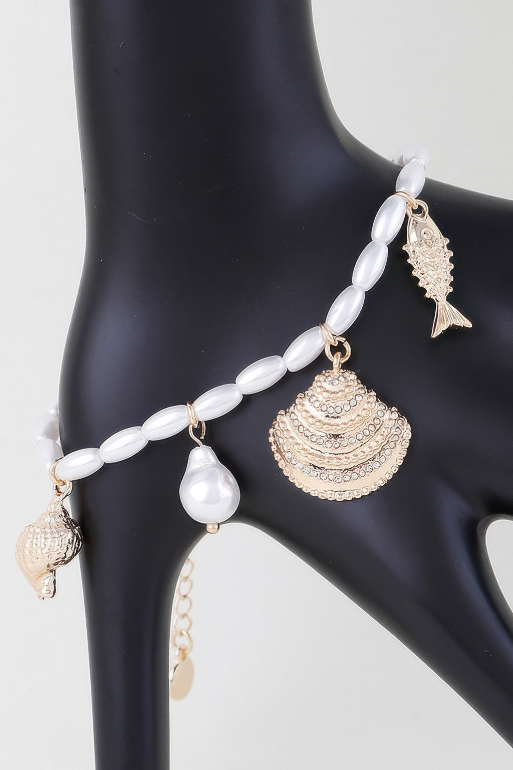 Jeweled Under The Sea bracelet with white beads, gold shell and fish charms
