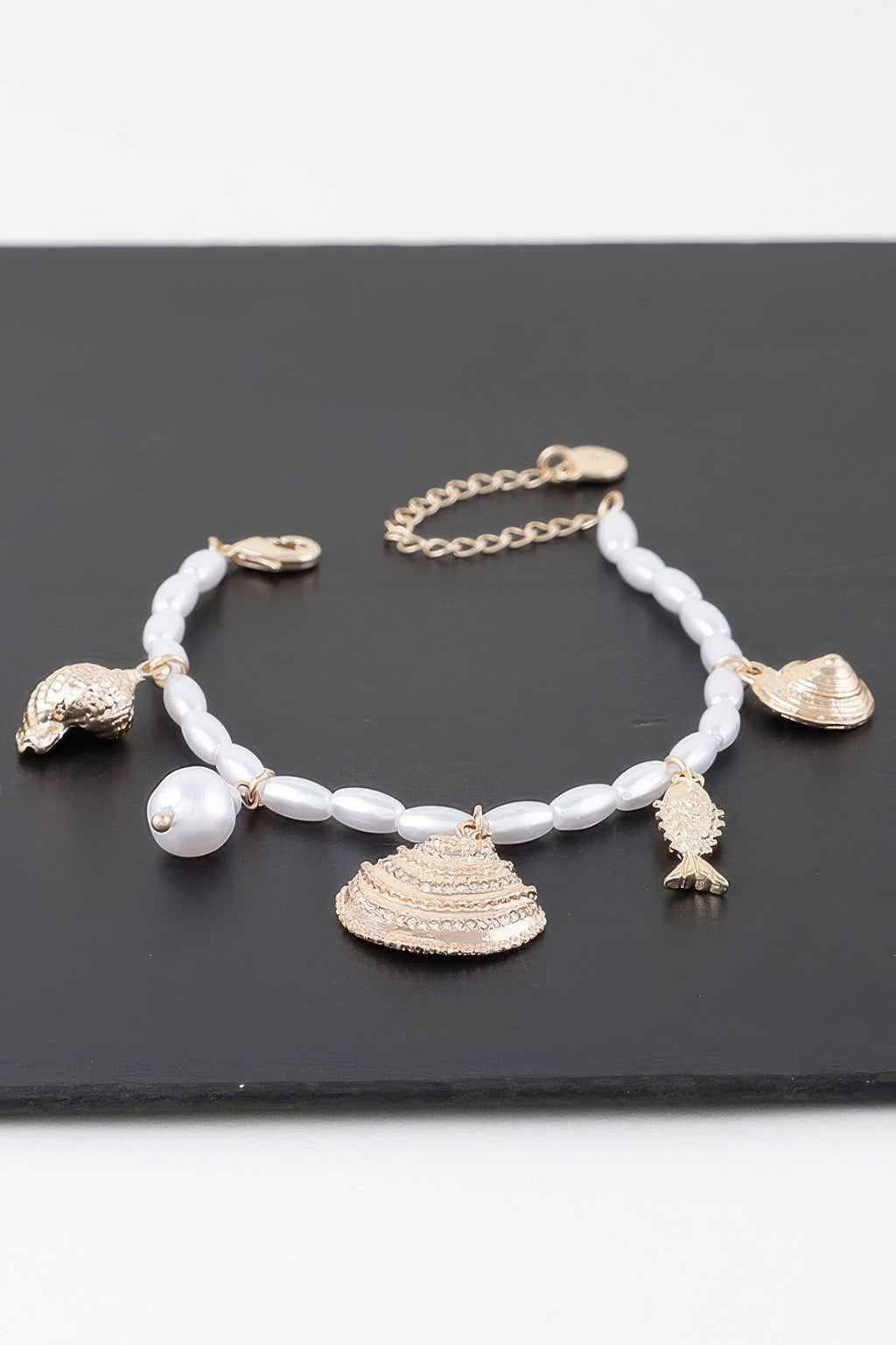 Under The Sea bracelet in gold cream: white bead strand with shell pendants