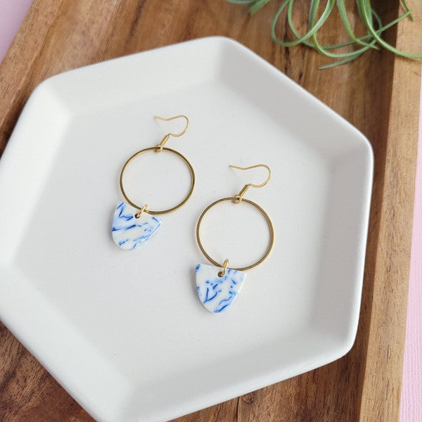 Gold hoop earrings with blue patterned drops, showing hook backs