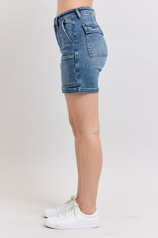Side view of medium-wash high-rise denim shorts with belt loops and pocket
