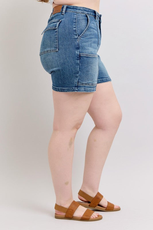 Back-side view of medium-wash high-rise denim shorts with back patch pockets