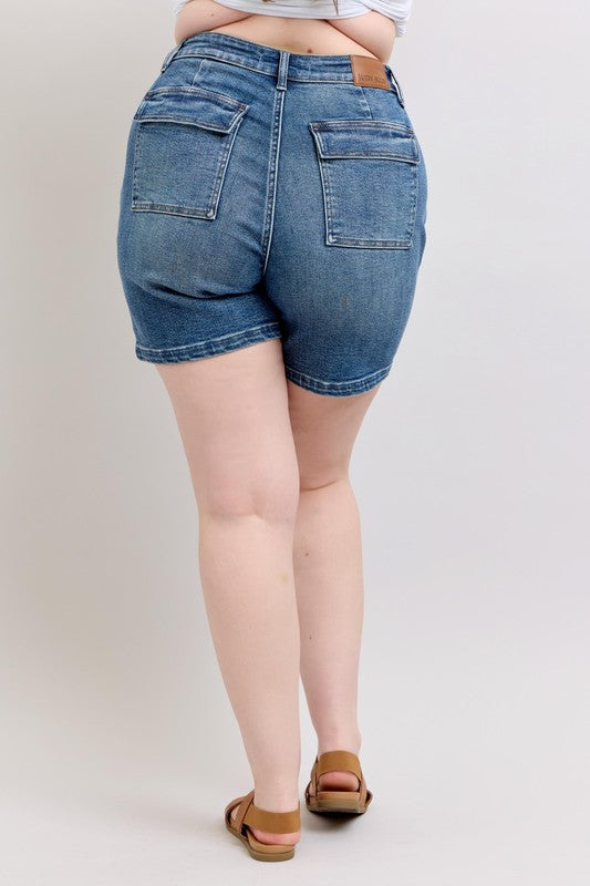 Back view of medium-wash high-rise denim shorts with patch pockets and belt loops