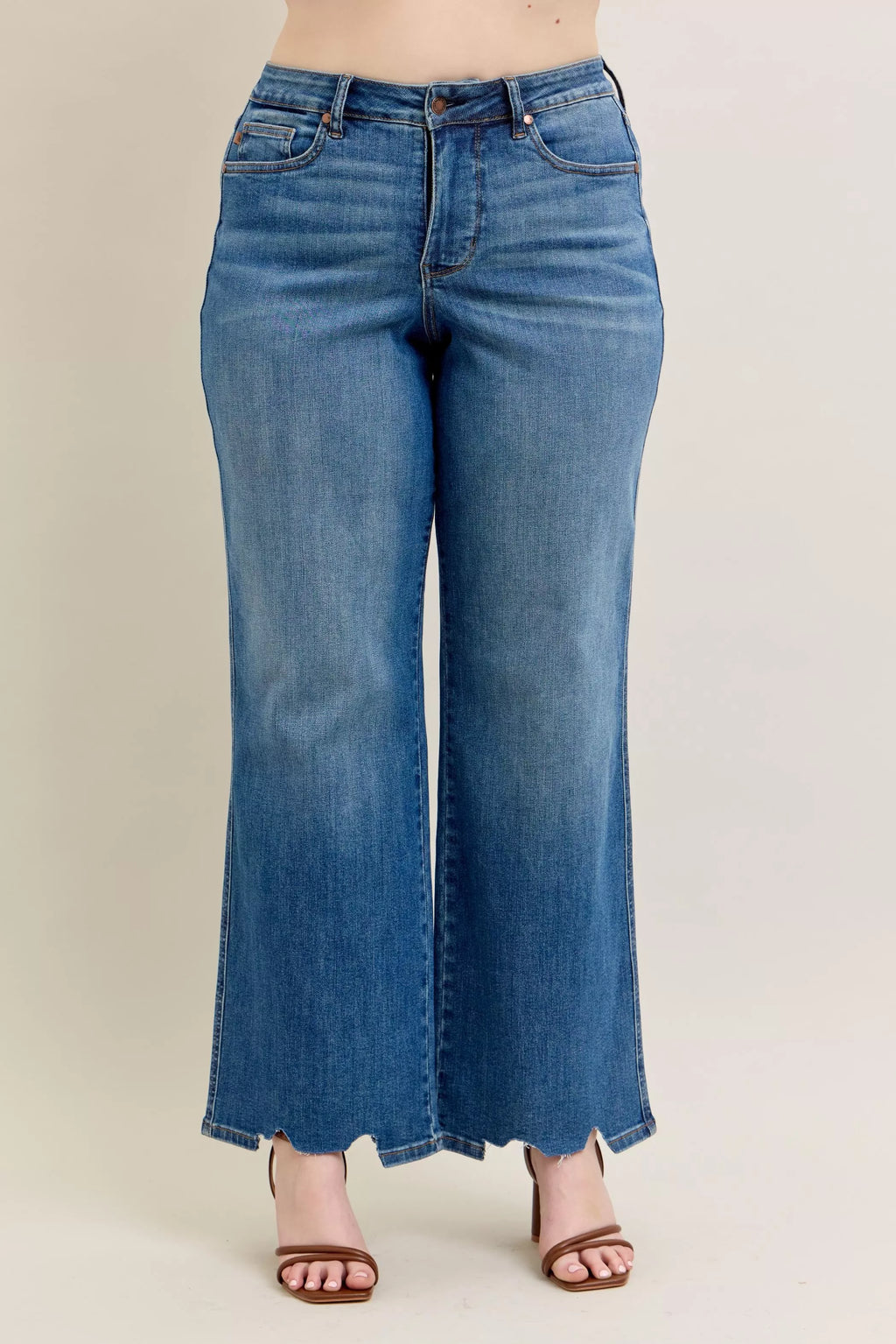 Mid-wash high-waist wide-leg jeans with torn “chew” style hem detail