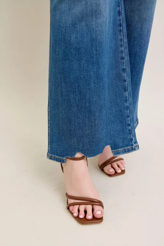 High-waist wide-leg jeans showing the destroyed, cutout hem and denim fray