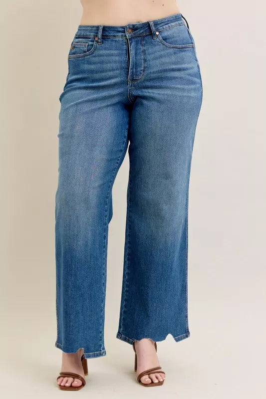 Mid-wash high-waist wide-leg jeans with subtle distress and ripped hem