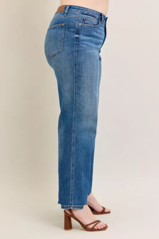 Back view of mid-wash high-waist wide-leg jeans with pockets and torn hem