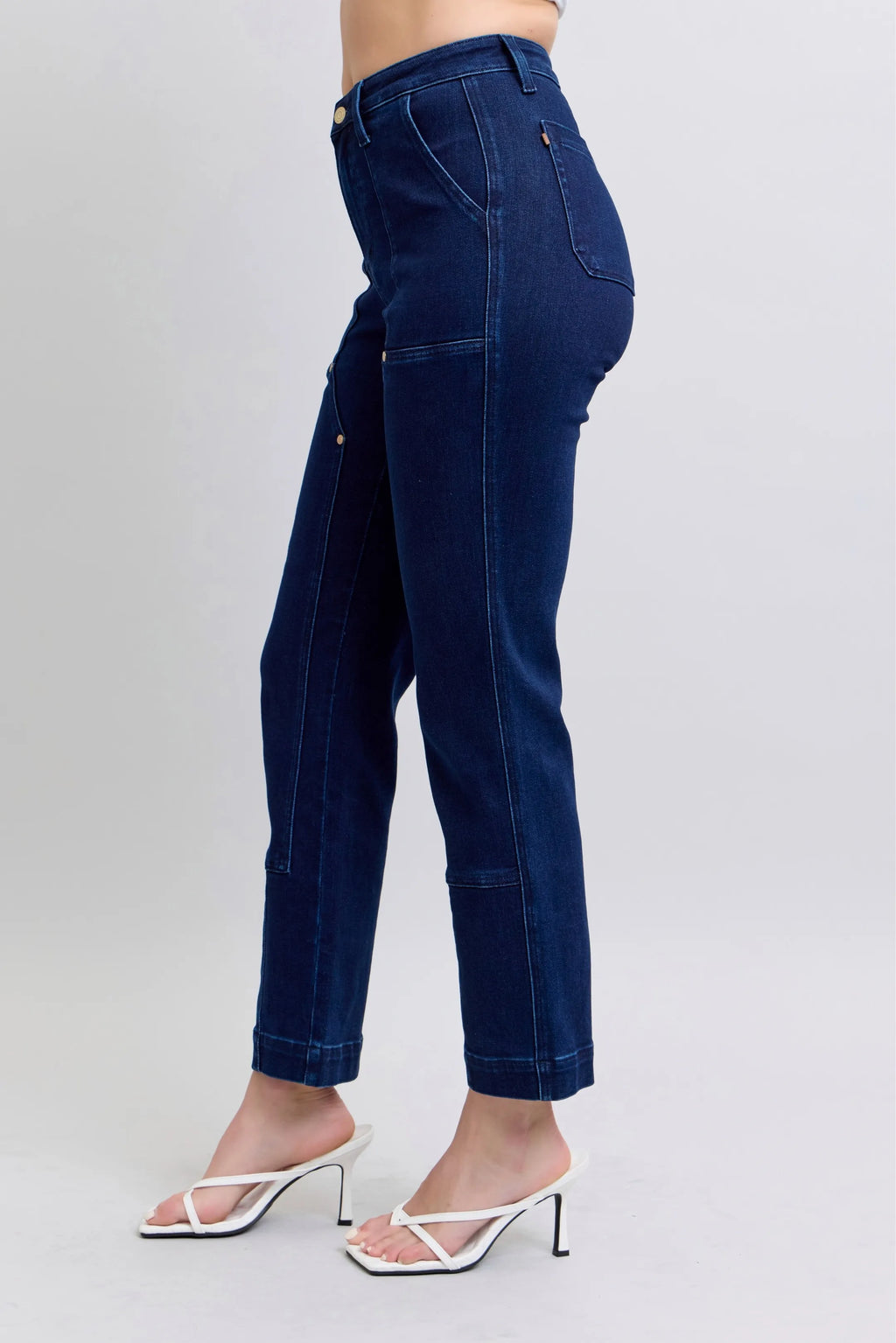 Dark blue straight jeans, back side view with knee patches at the knees.