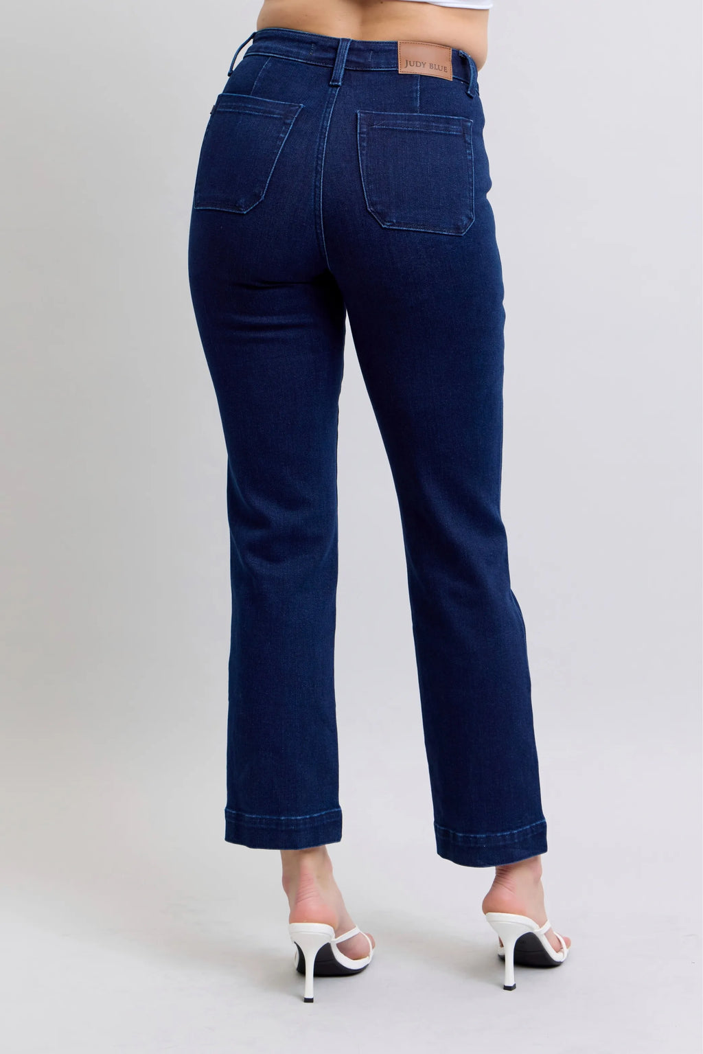 Dark blue straight jeans with knee patches, front/back pockets, belt loops.