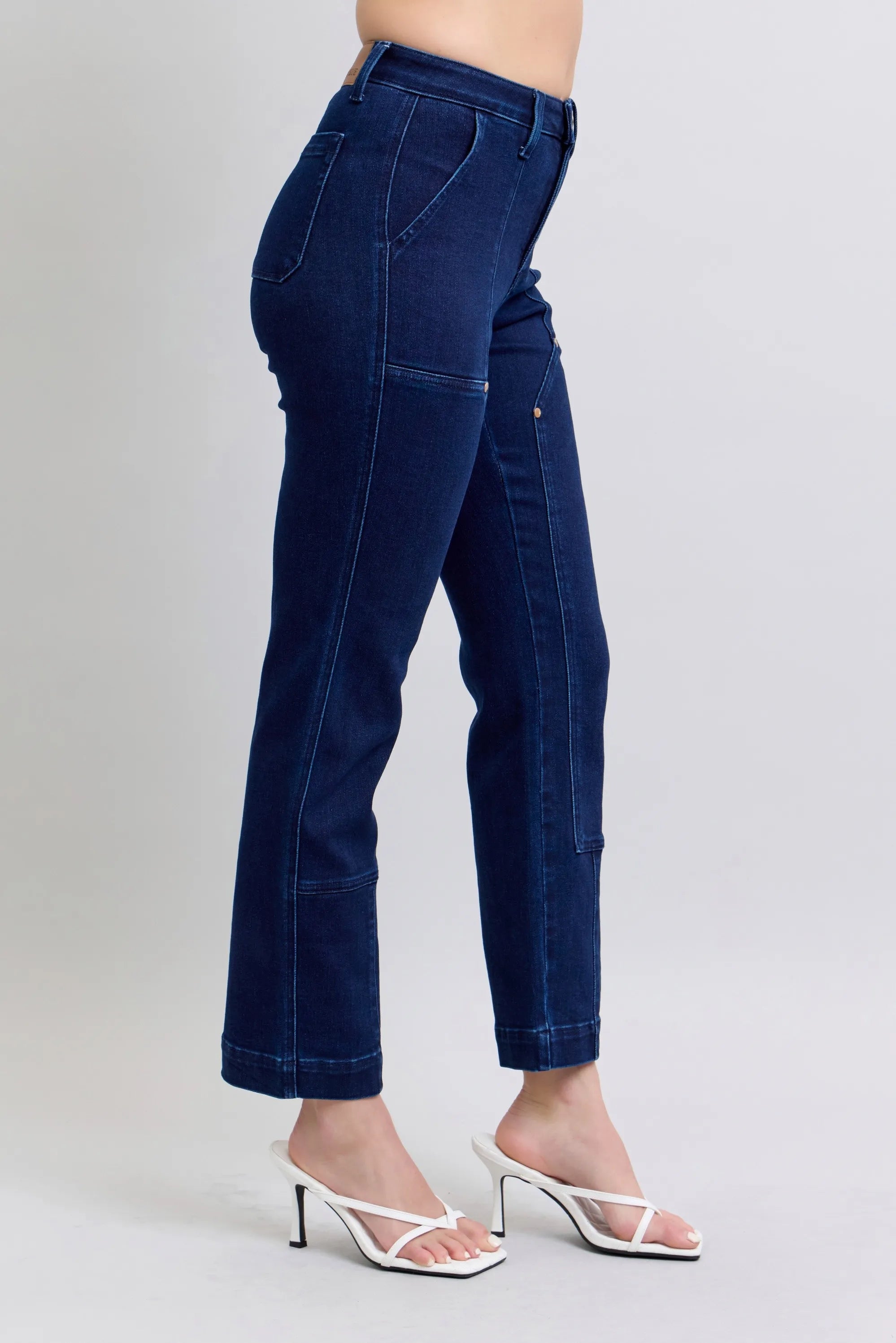 Dark blue straight jeans, opposite side view with knee patch reinforcement.