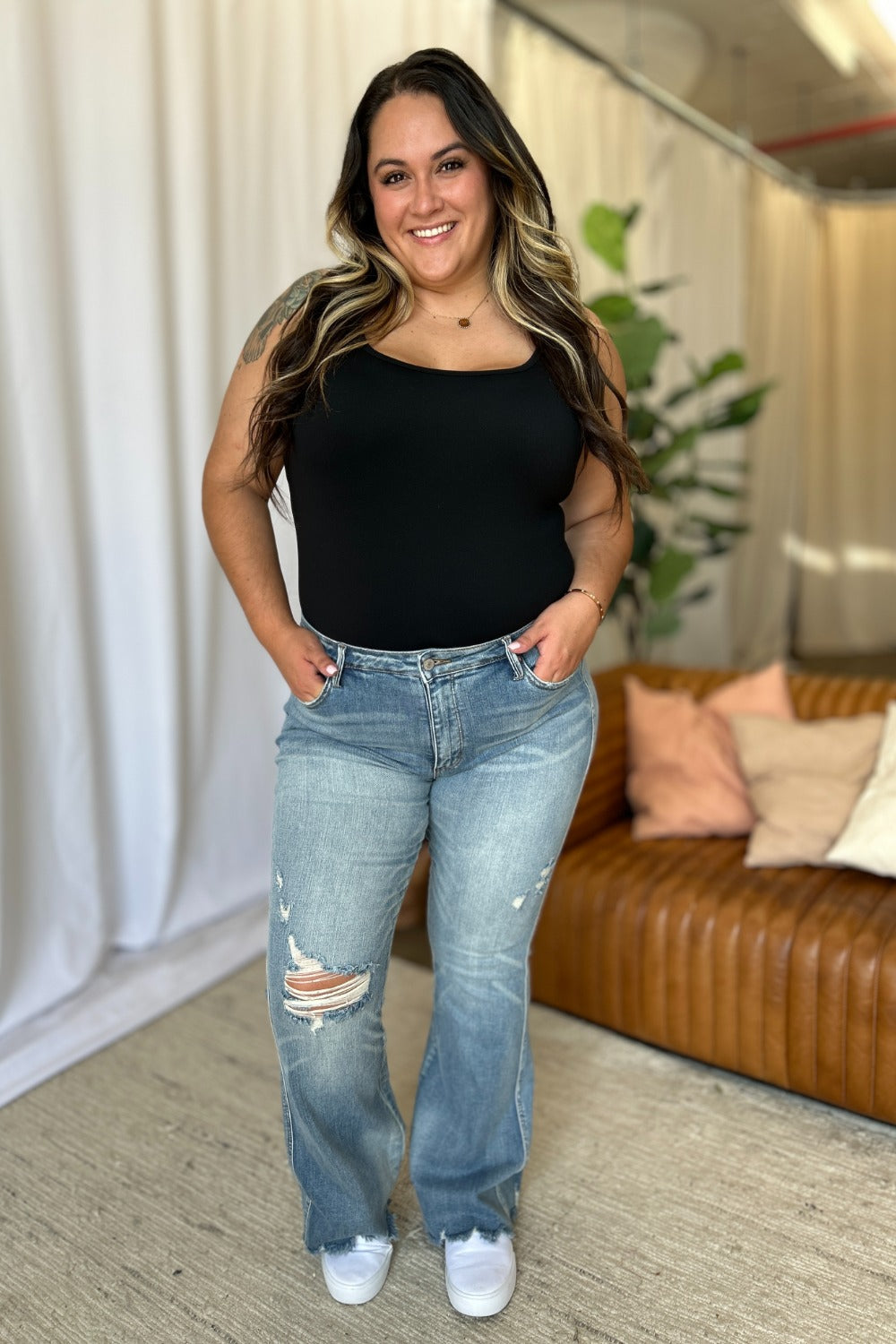 Light-wash medium-rise destroy flare jeans with distressed knee rips and flared leg