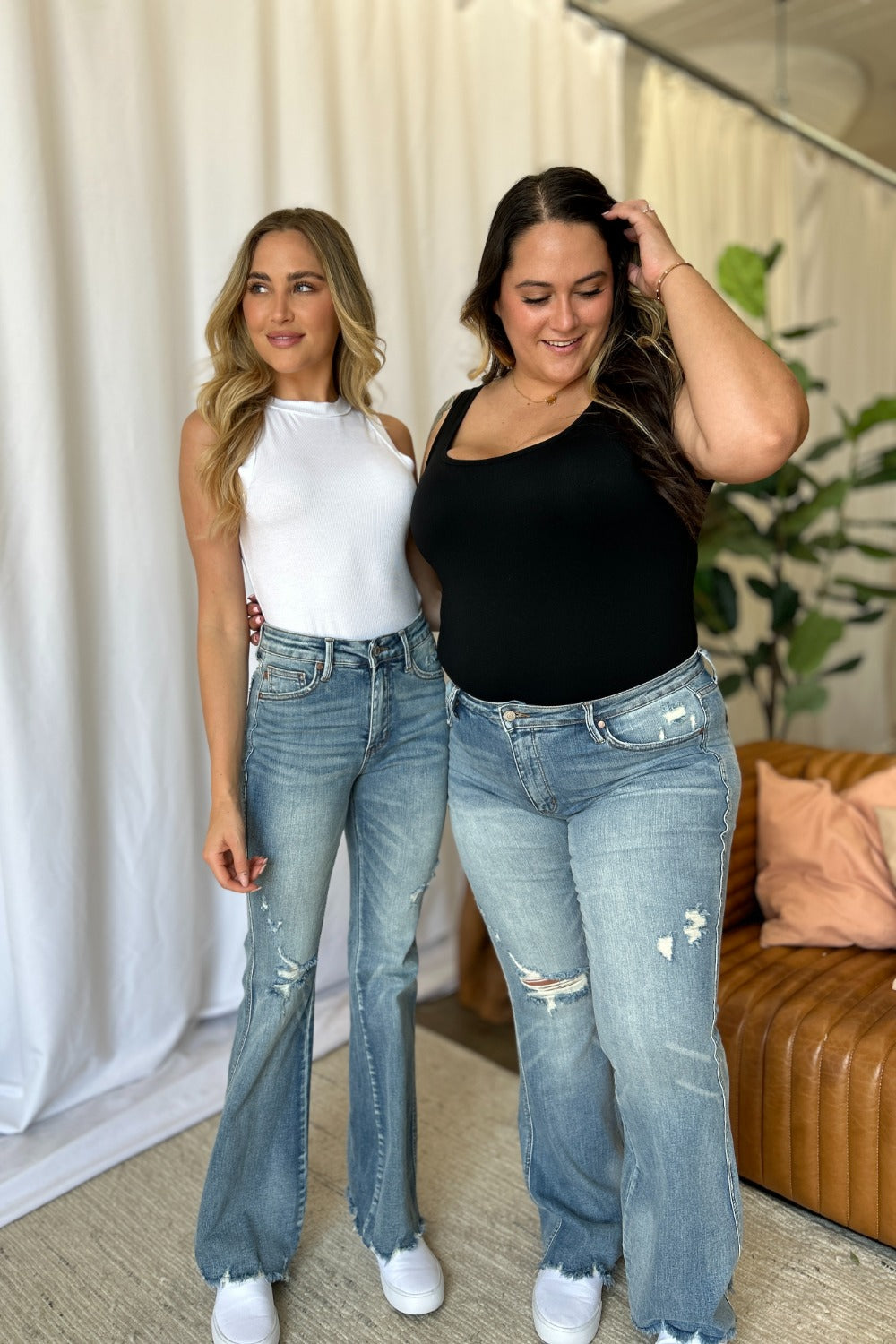 Medium-rise destroy flare jeans in light wash, distressed hem and knee rips