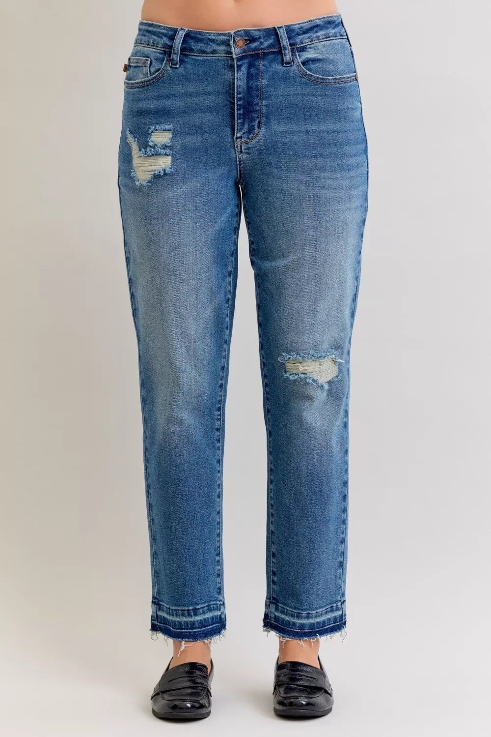 Mid-rise straight jeans in medium blue wash, with ripped knees and release hem cuffs