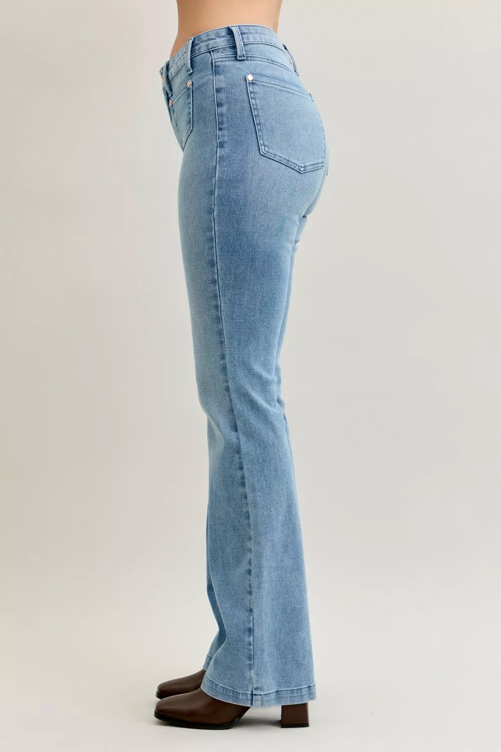 Light blue mid-rise bootcut jeans, back view, patch pocket detailing and contrast wash