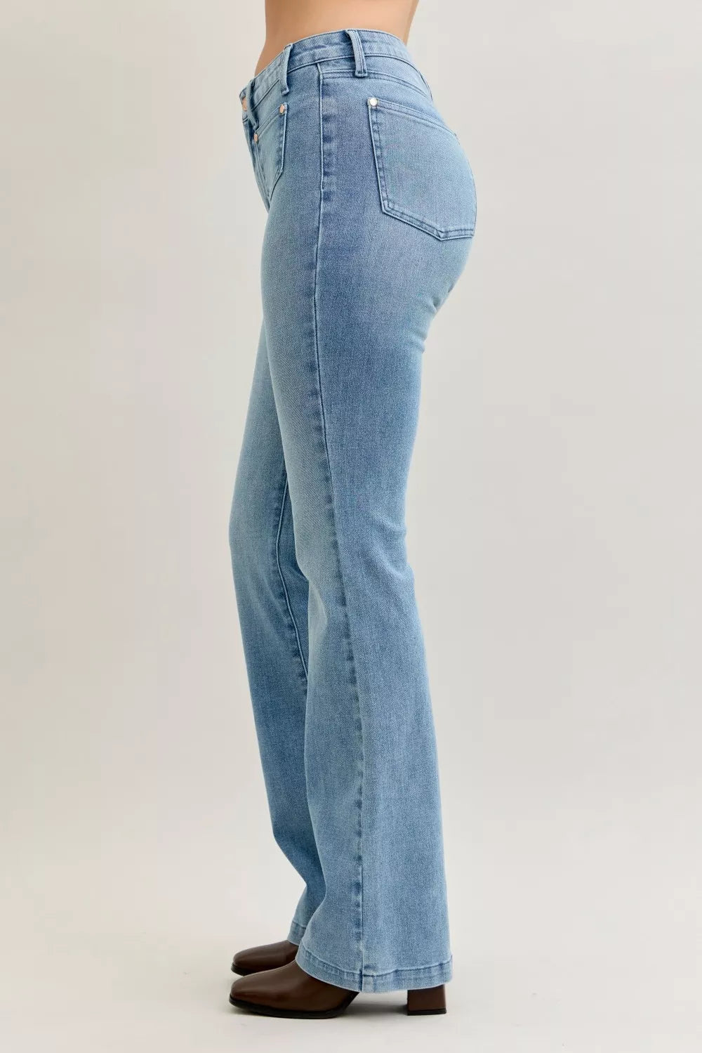 Light blue mid-rise bootcut jeans, side-back view, contrast wash seam details