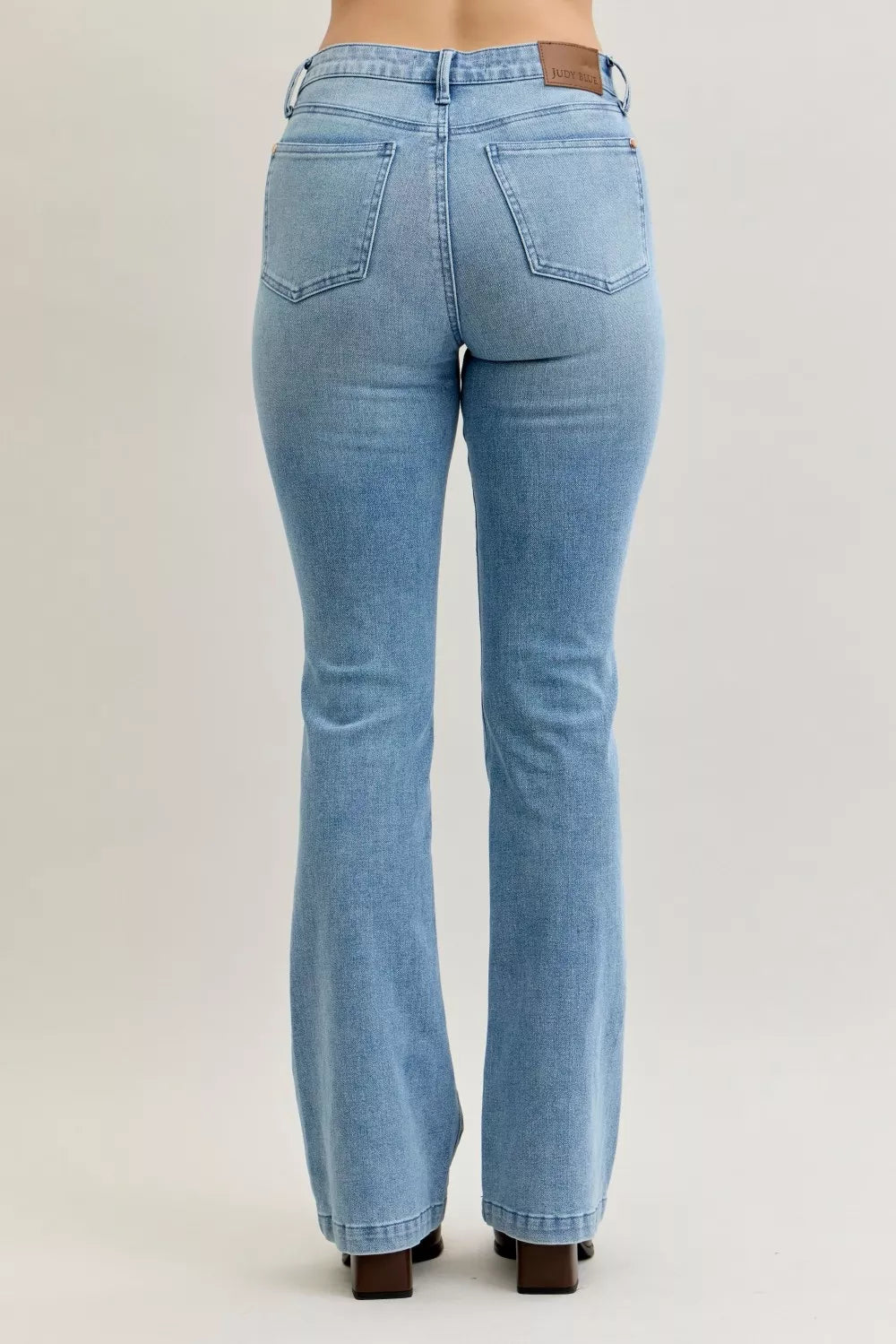 Light blue mid-rise bootcut jeans, back view, dual patch pockets and contrast wash