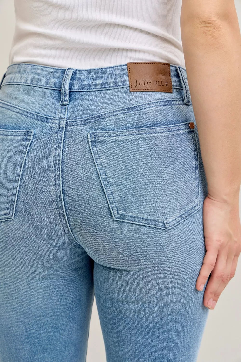 Light blue mid-rise jeans with front patch pockets and Judy Blue logo leather tab