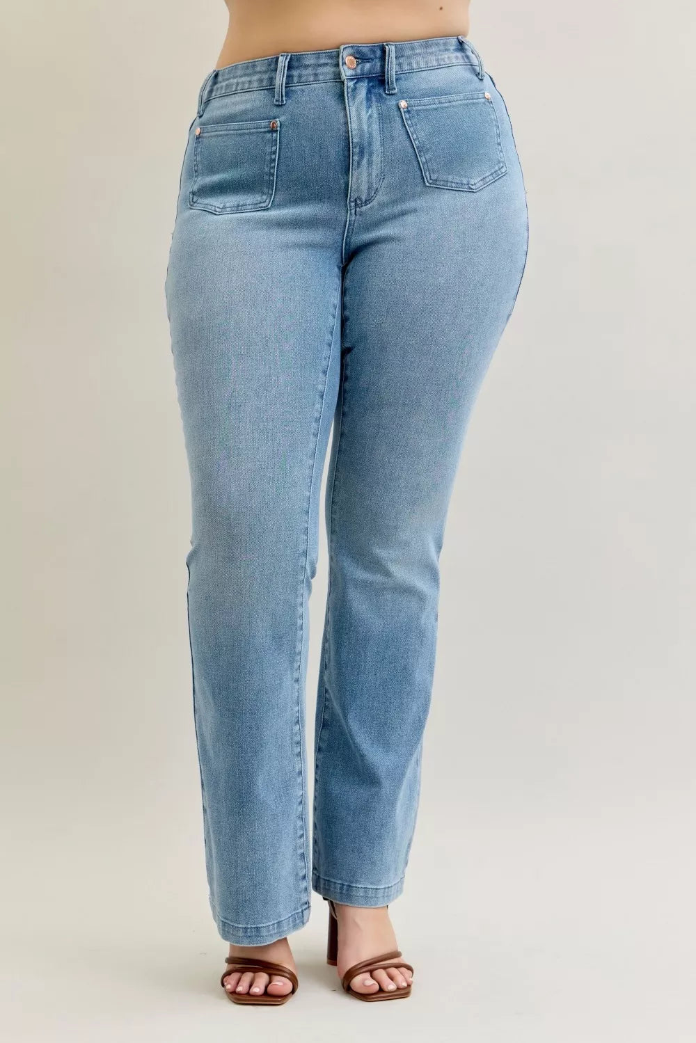 Light wash mid-rise bootcut jeans with front patch pockets and contrast detailing