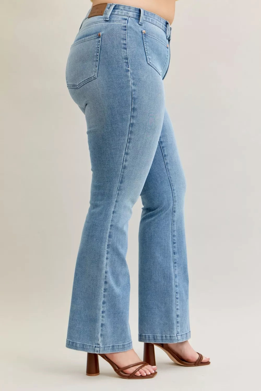 Back view light wash bootcut jeans with two patch pockets and contrast stitching