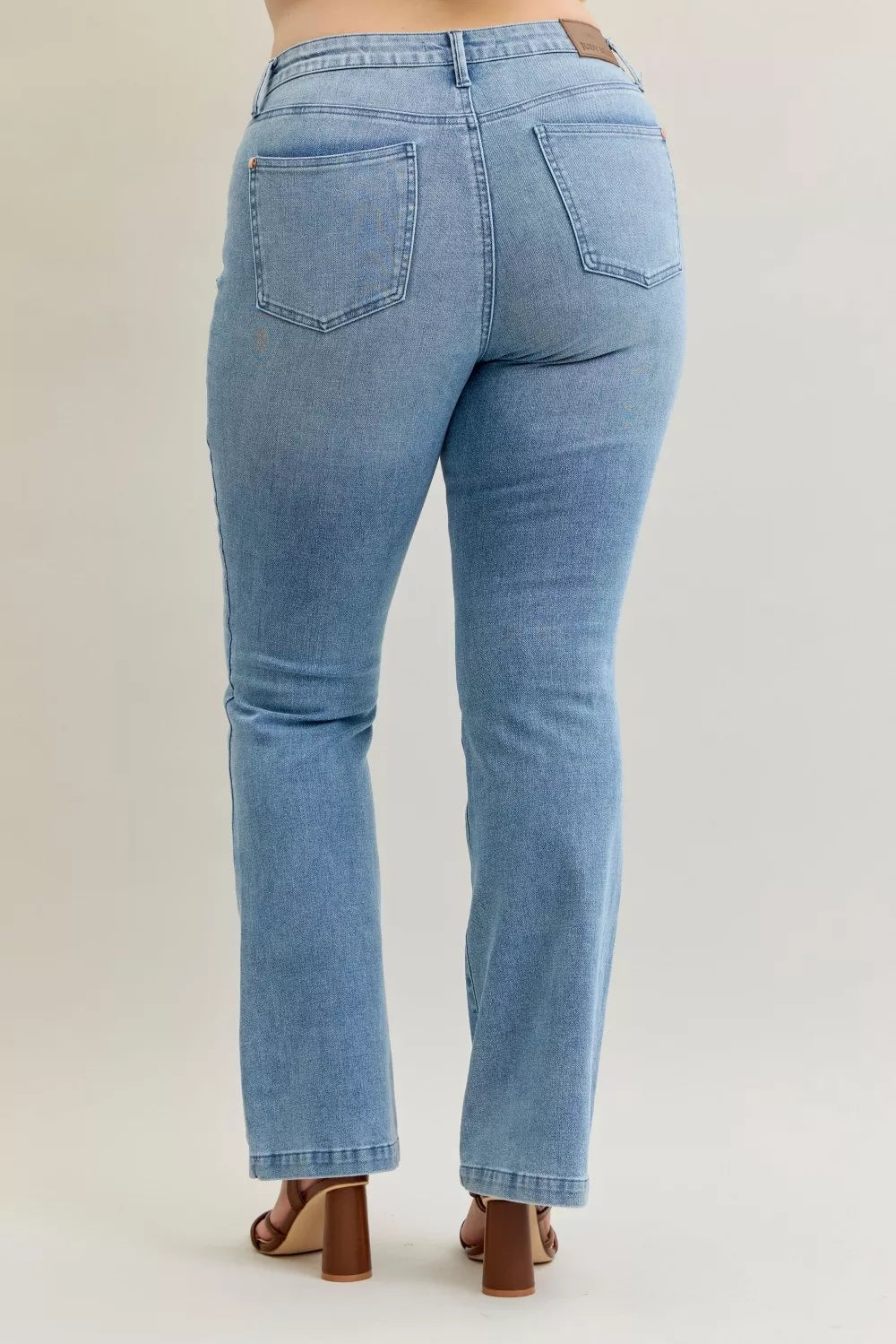 Light wash mid-rise bootcut jeans with back patch pockets and straight waistband