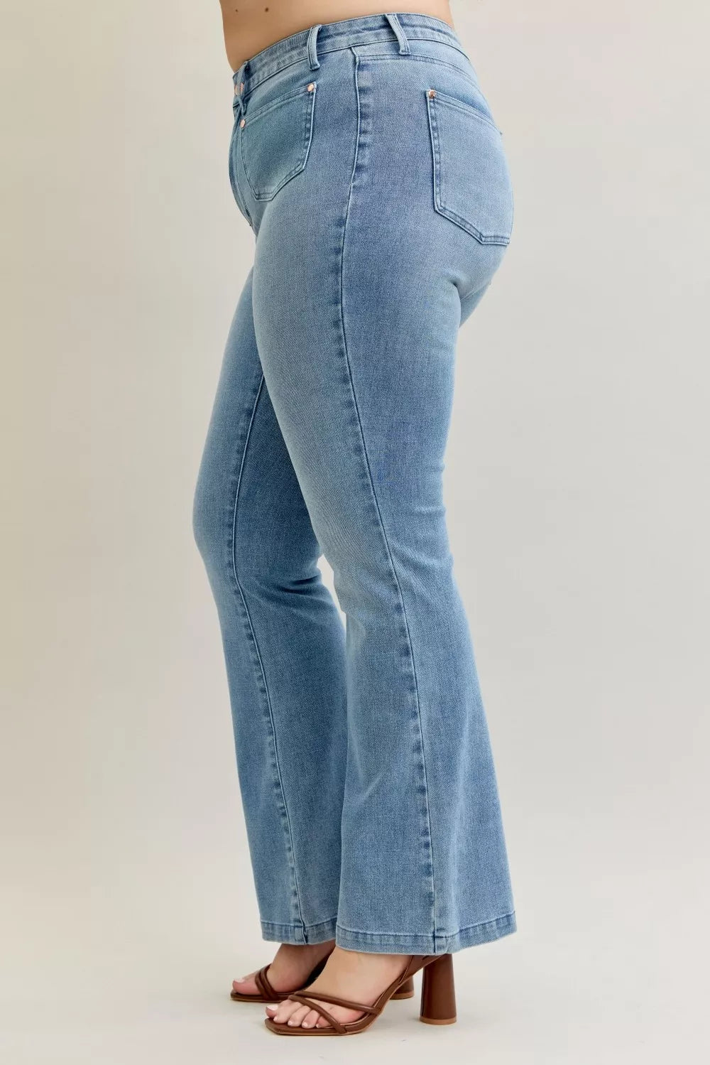 Back view medium-dark wash bootcut jeans with patch pockets and seam lines