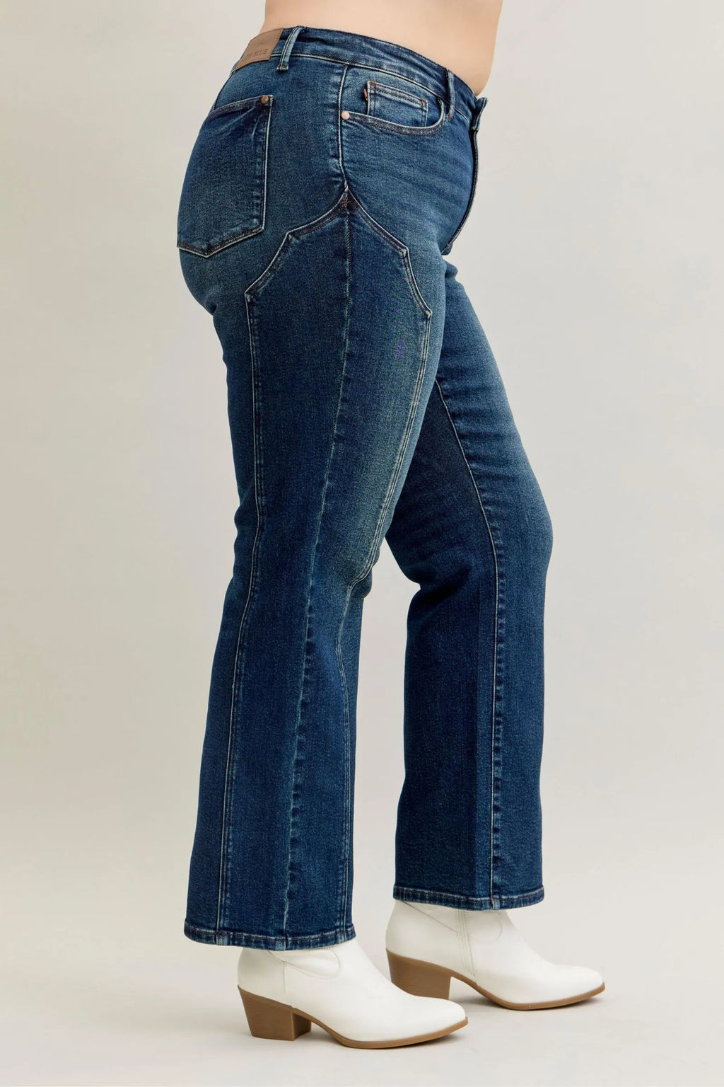 Dark denim jeans with curved yoke seam and back patch pockets