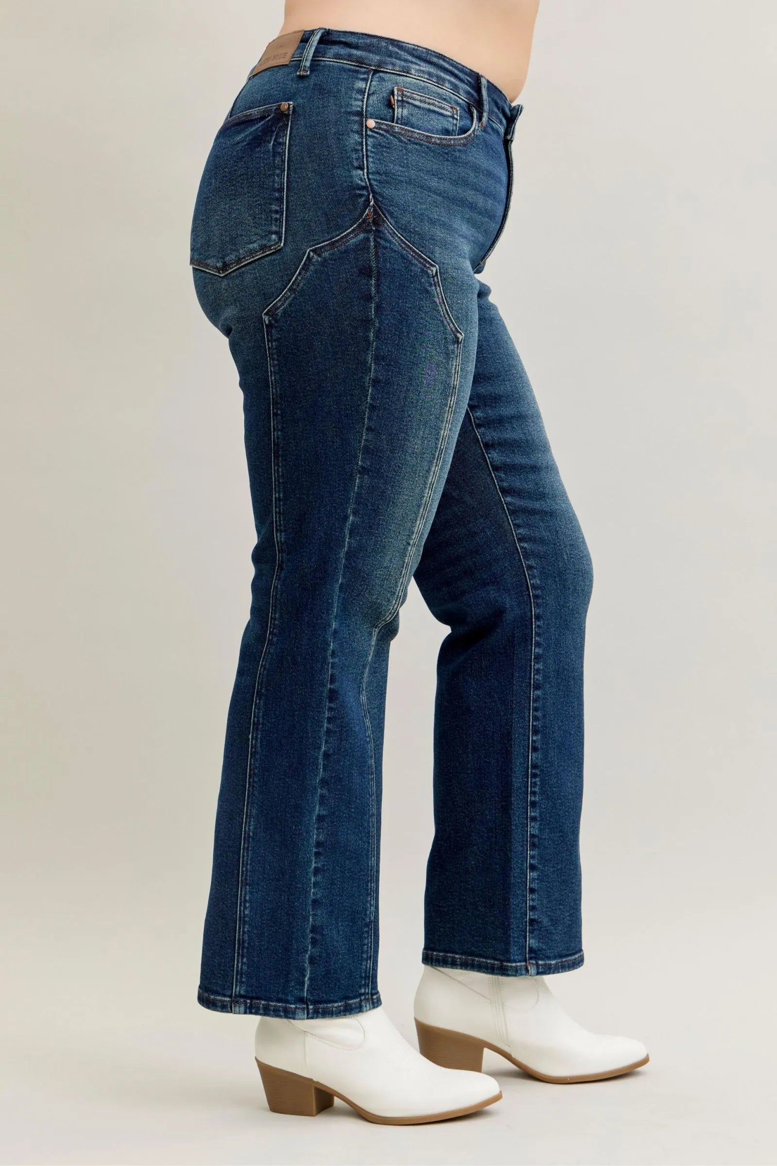 Dark denim jeans with curved yoke seam and back patch pockets