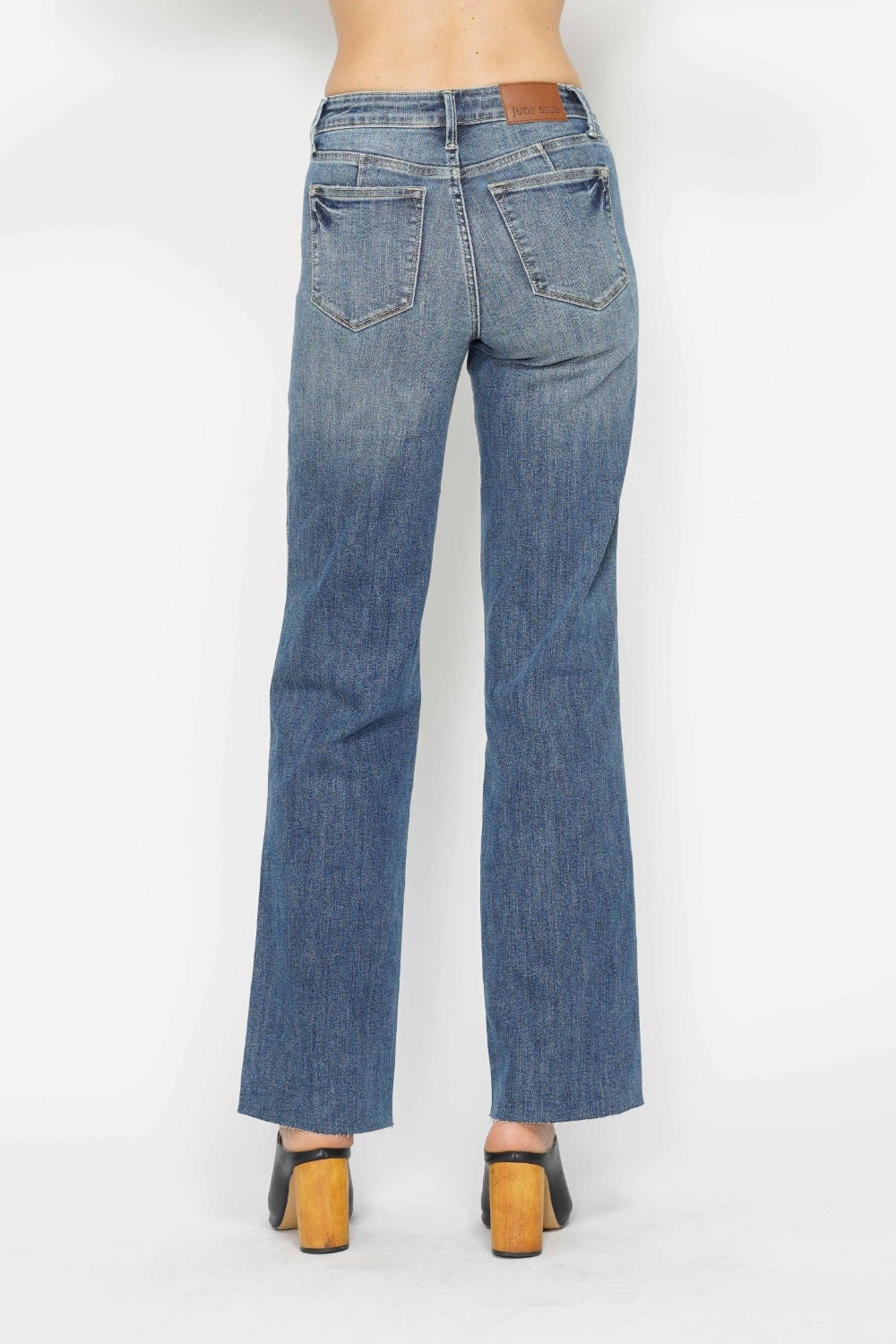 Medium-wash straight jeans, back view with two patch pockets and belt loops