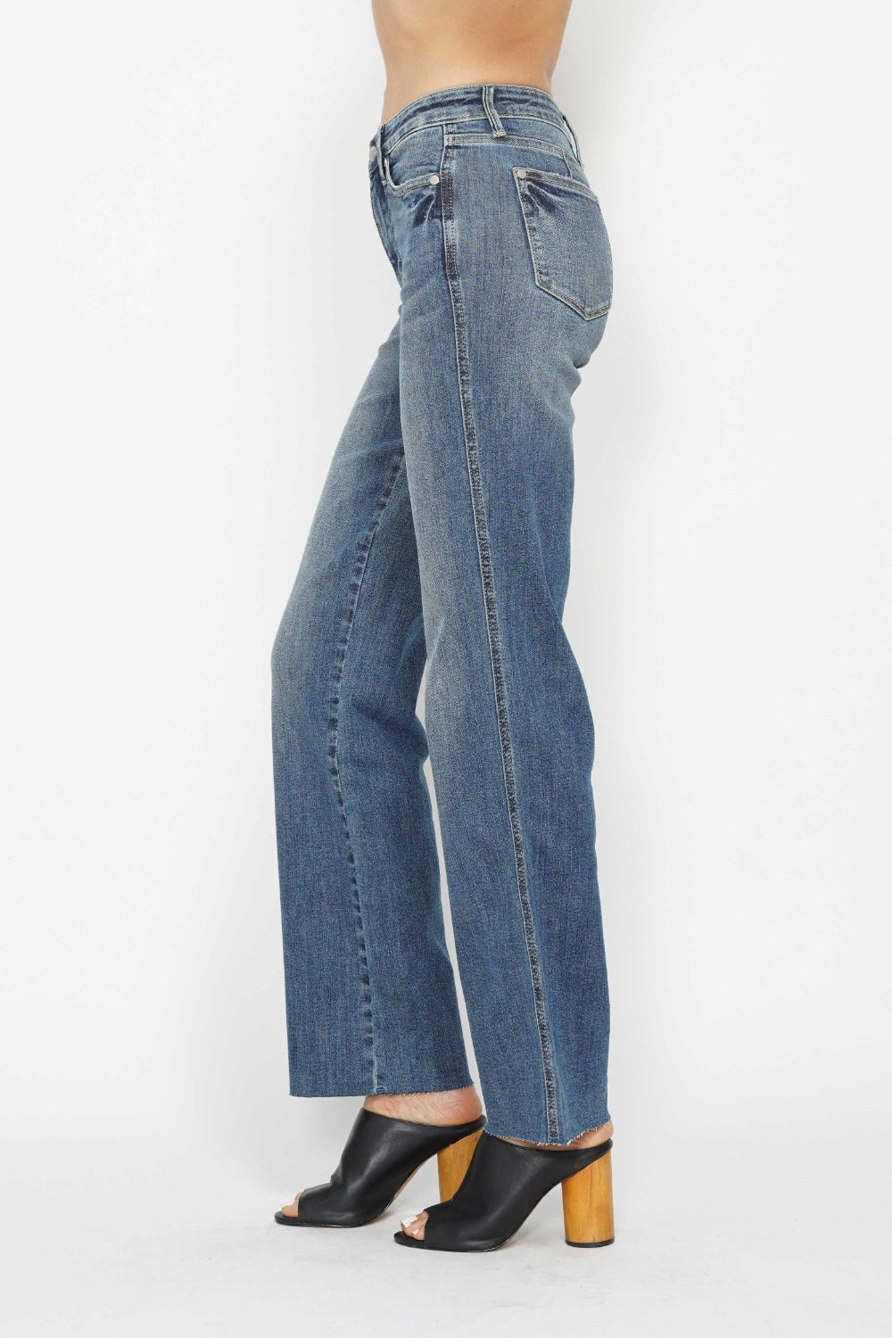 Medium-wash straight jeans, side profile with stitched seams and front pocket