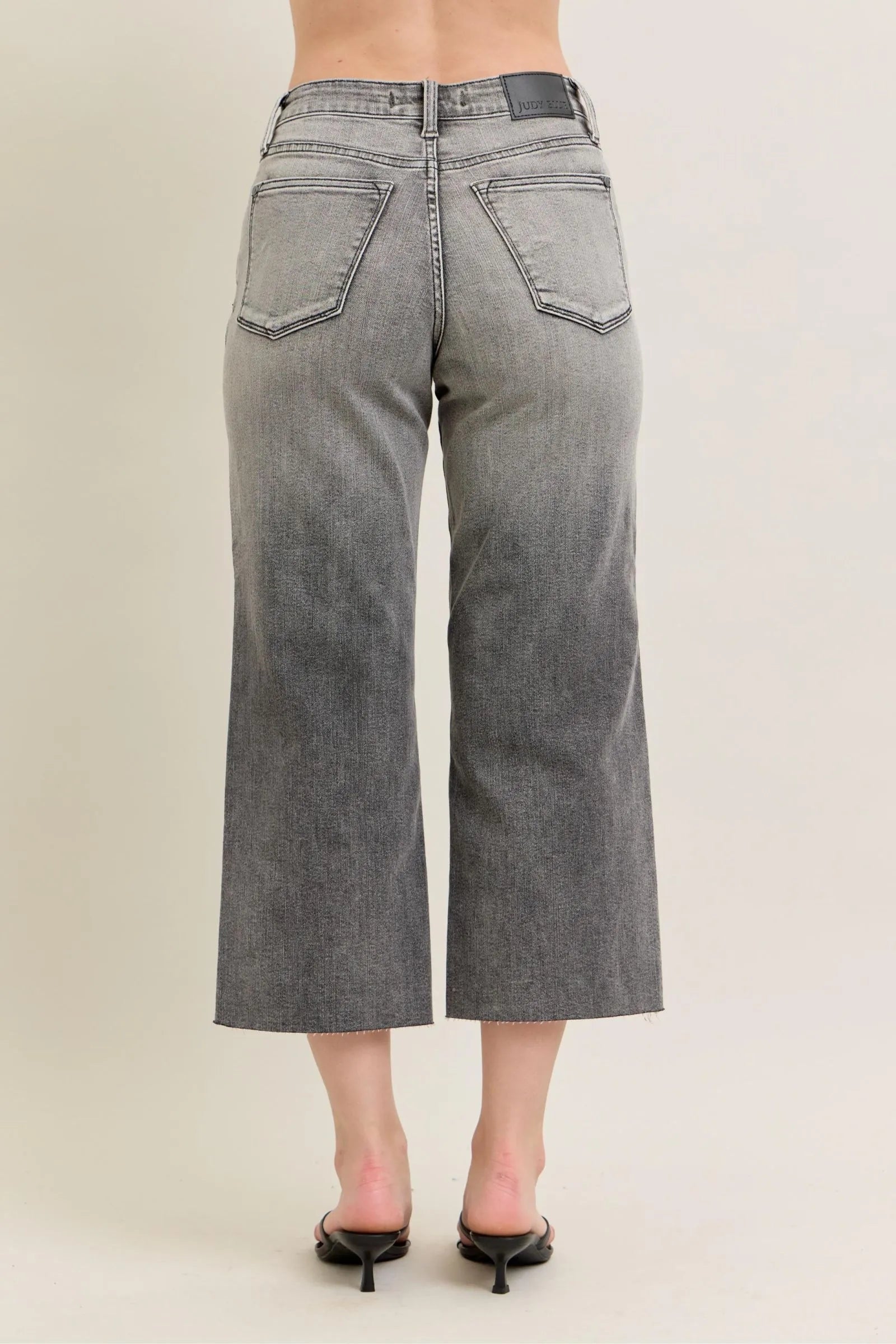 Gray wide-leg capri jeans, back view with two patch pockets and yoke seam