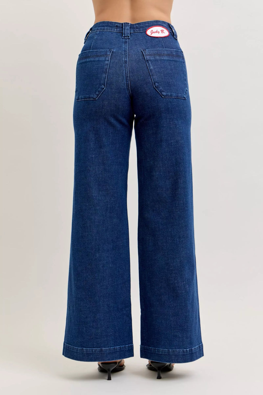 High-waisted wide-leg jeans, dark wash, rear patch pockets, stitched seams