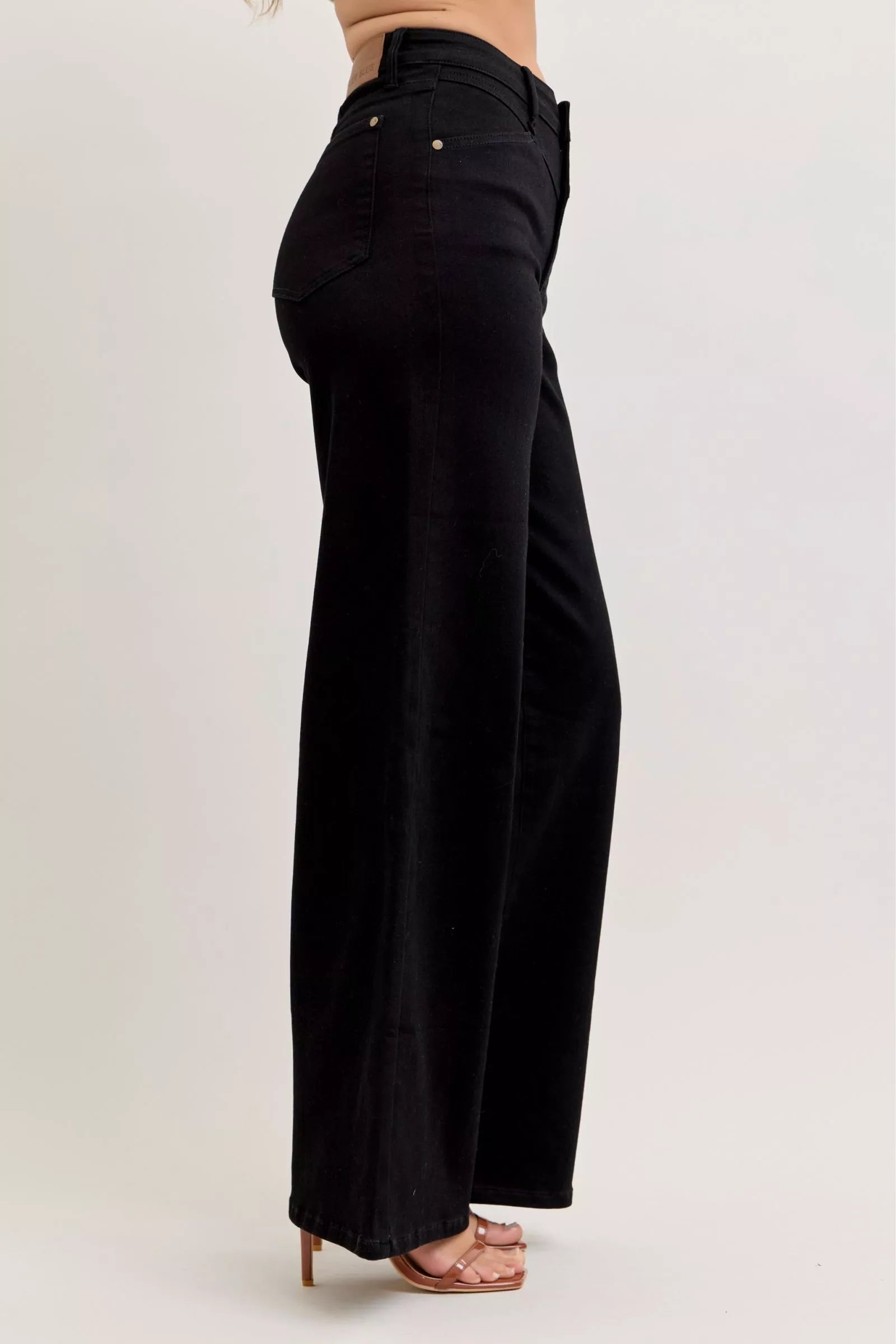 Black high-waisted wide-leg jeans, side view with belt loops and front pockets