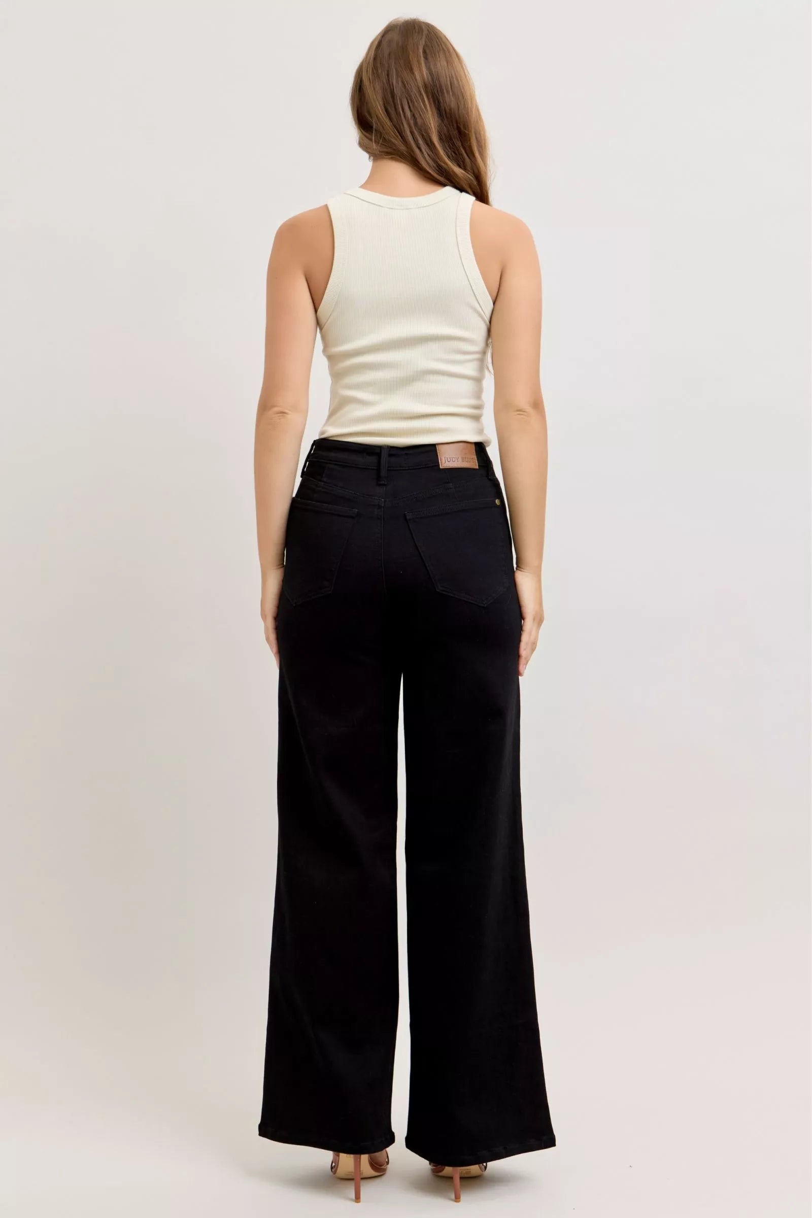 Black high-waisted wide-leg jeans, back view with belt loops and back pockets
