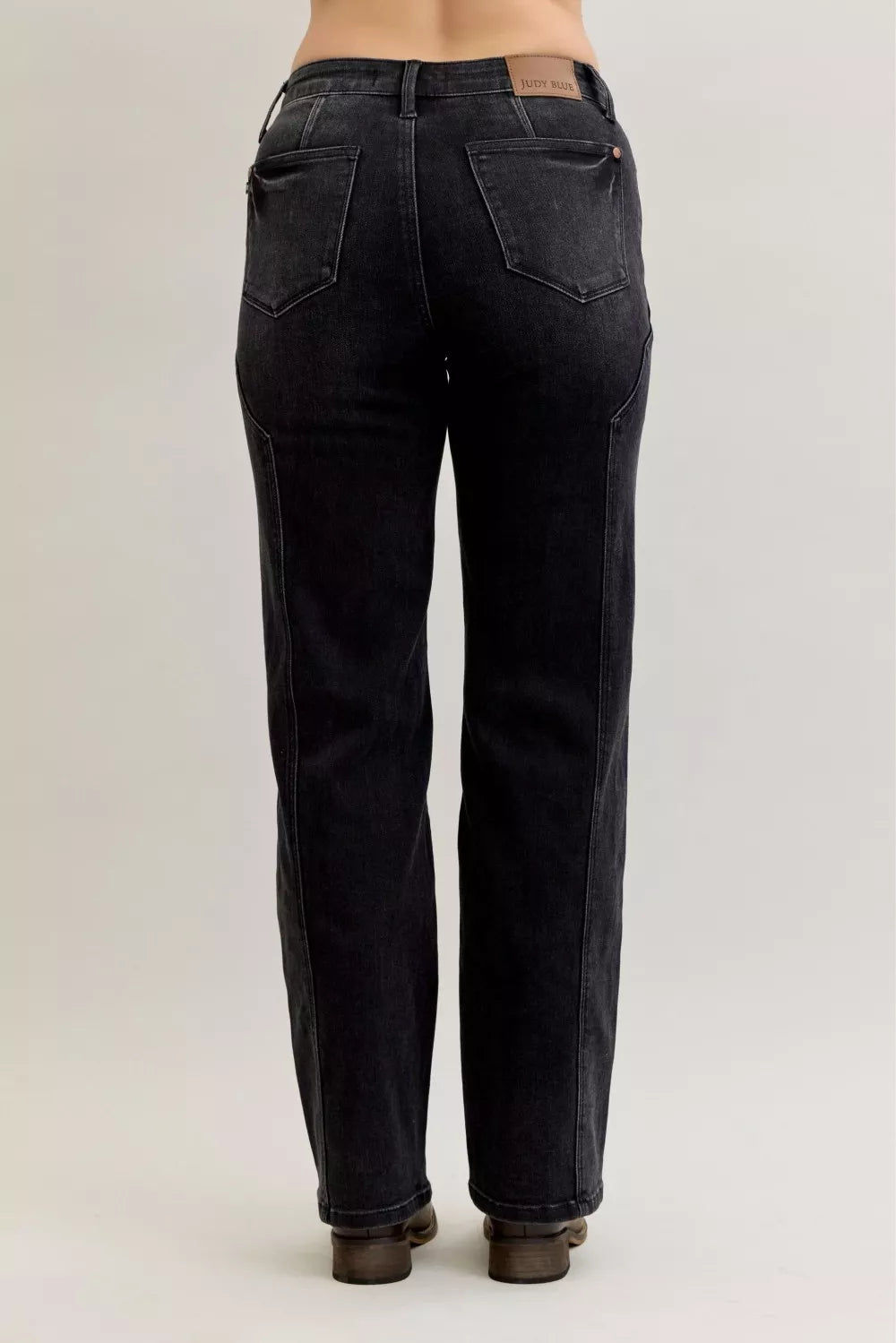 Black mid-rise straight jeans, back view with central button and yoke