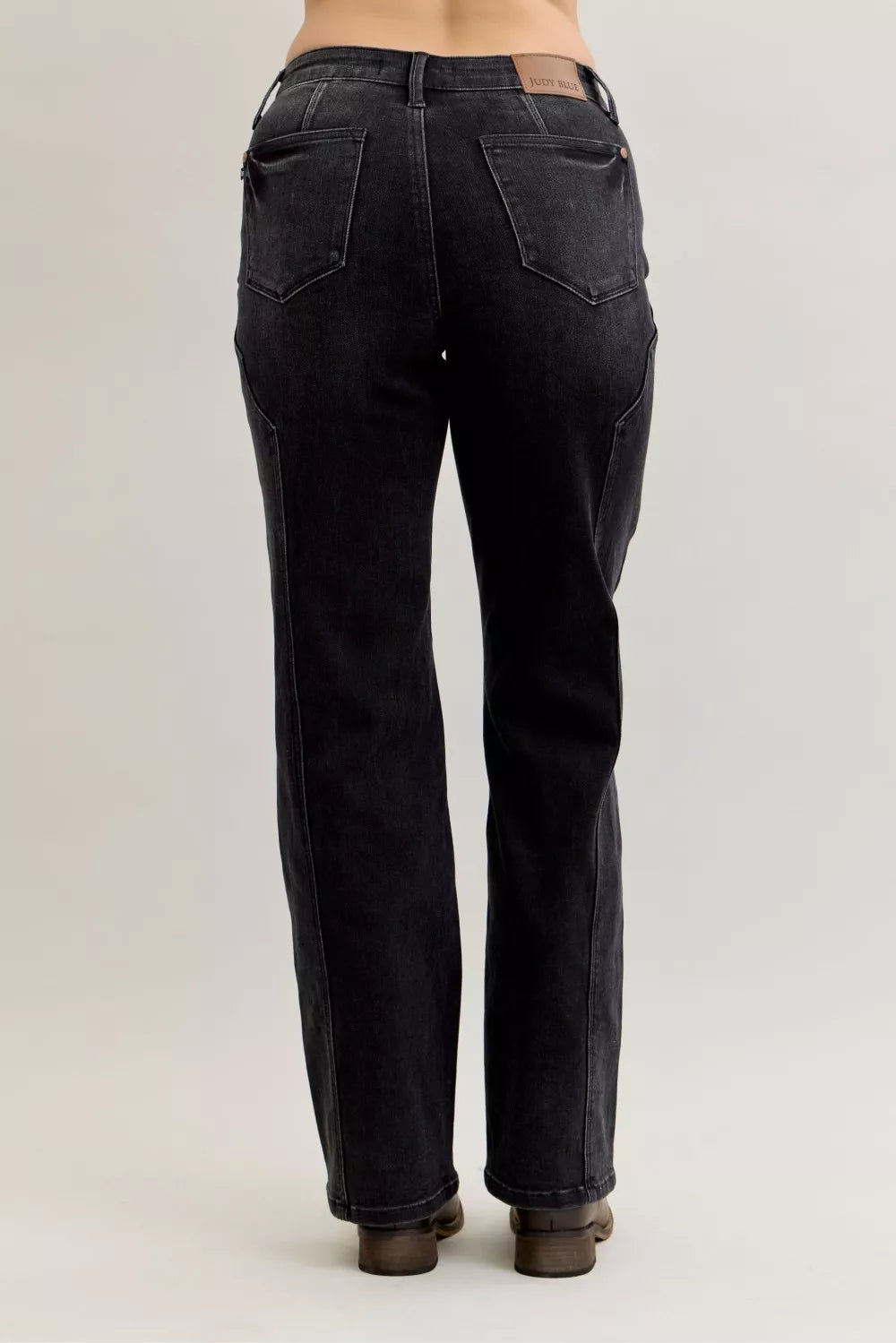 Black mid-rise straight jeans, back view showing yoke and rear pocket seams