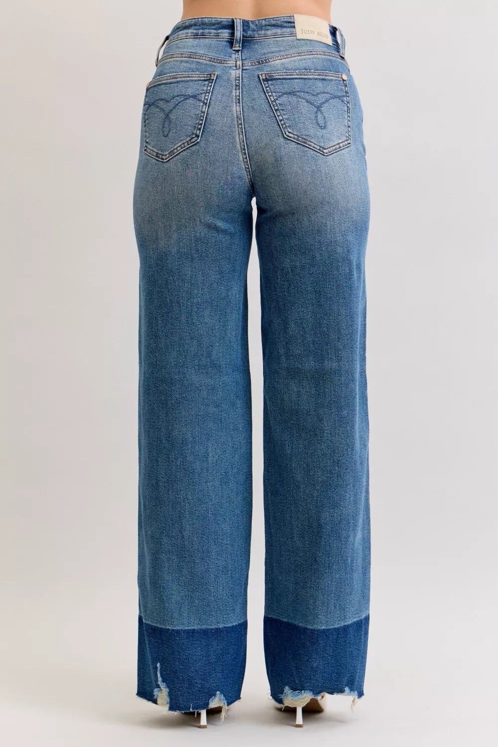 High-waist jeans in dark wash (DK), back with angled pockets