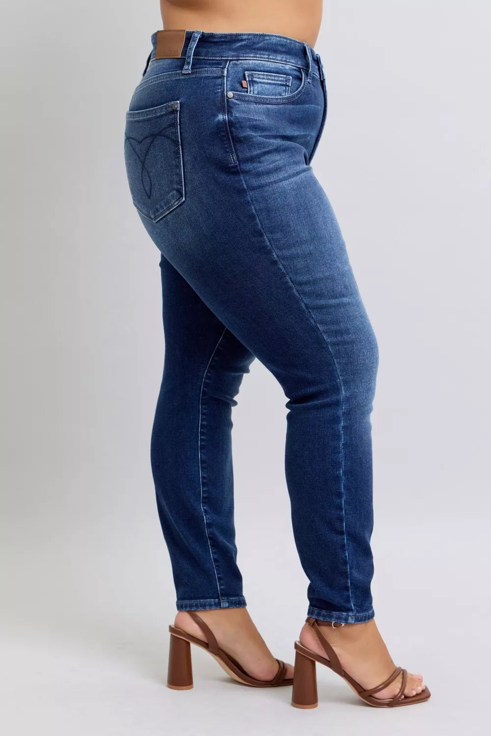 Dark blue washed thermal skinny jeans back view, stitched back pockets and slim fit
