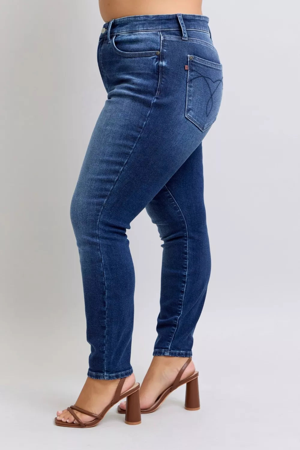 Dark blue washed thermal skinny jeans back view, stitched seams and tapered ankle