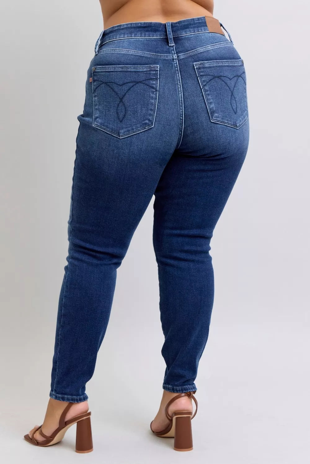 Dark blue washed thermal skinny jeans back view with denim whiskering and skinny silhouette