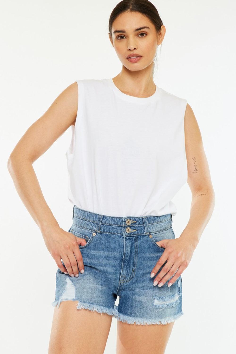 High-rise medium-blue denim shorts, frayed raw hem and buttoned fly