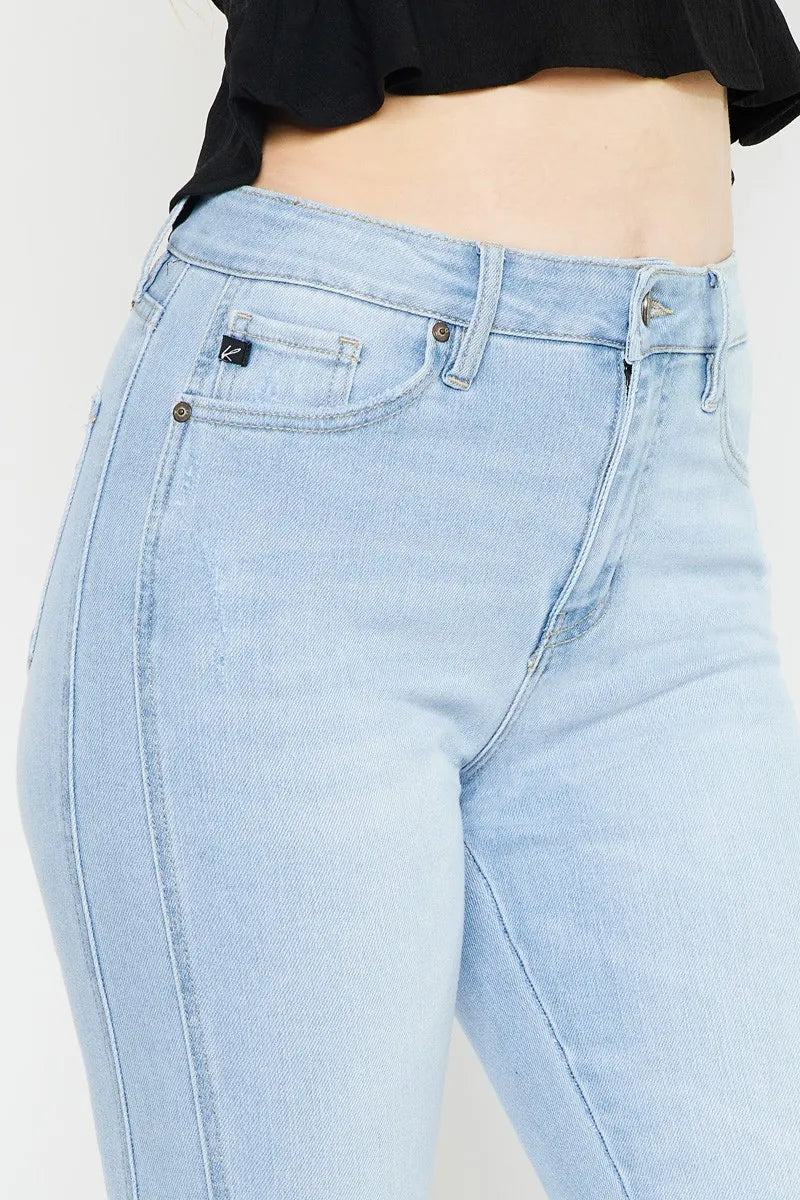 Close-up of light wash high-rise jeans: K label patch, front pocket, belt loops
