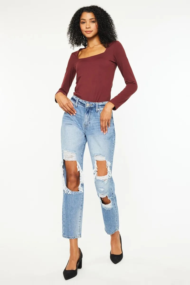 High-rise boyfriend jeans in medium wash with large thigh and knee rips, cuffed hem