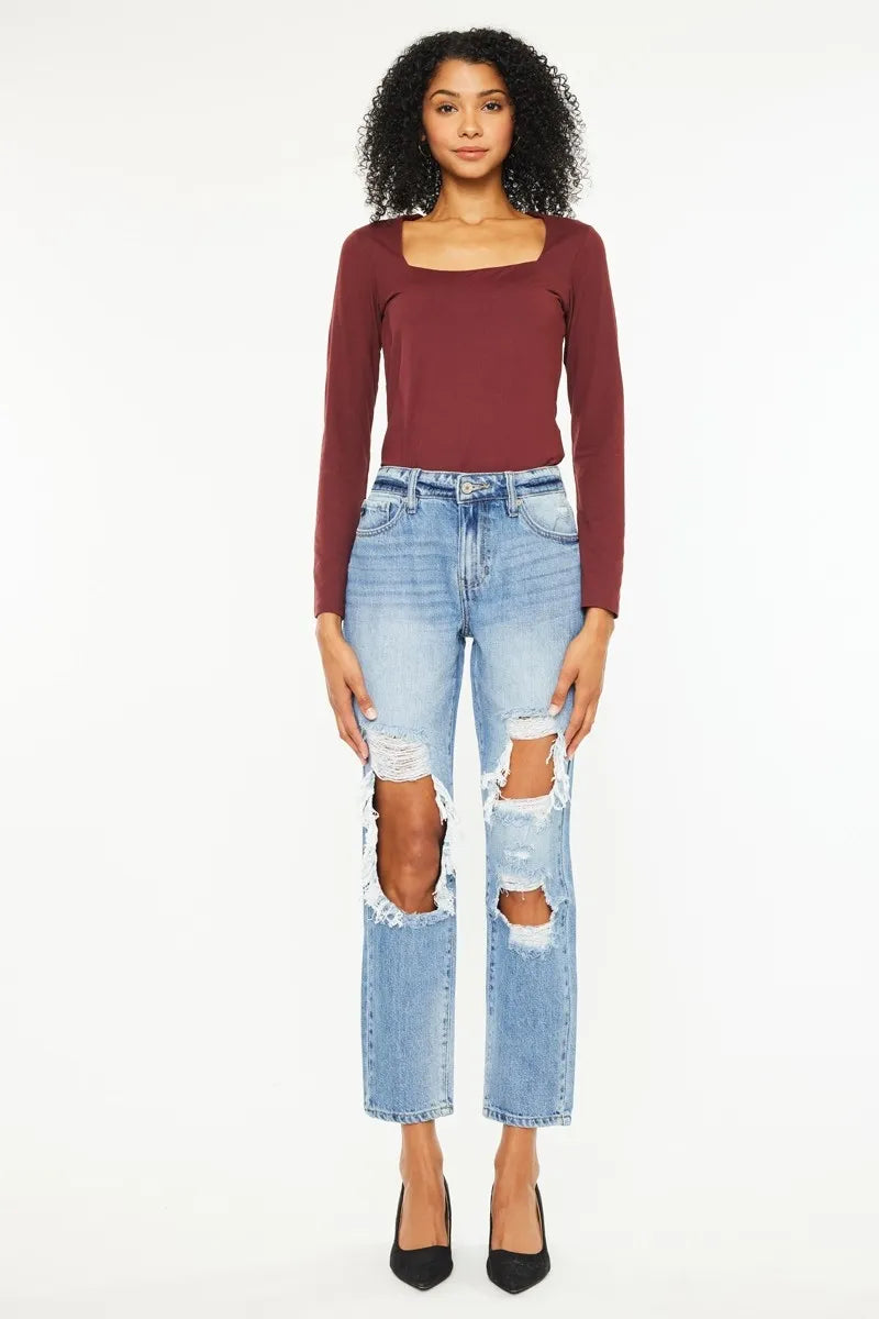 Medium wash high rise boyfriend jeans with distressed thigh rips and straight cropped legs