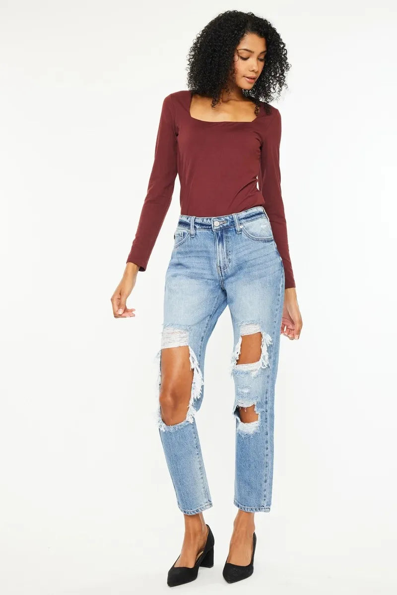 Medium wash boyfriend jeans with high-rise fit, distressed knees, and frayed leg openings