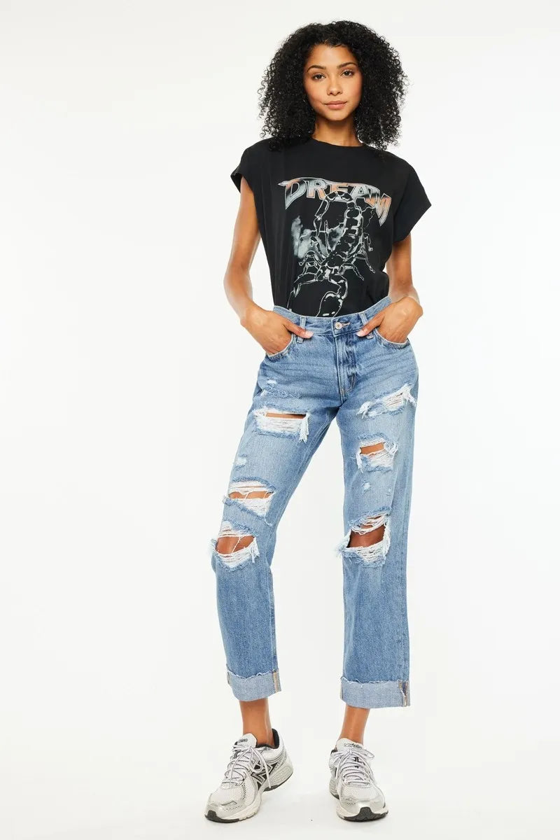 Medium-wash mid-rise boyfriend jeans with ripped knees and frayed cuffs
