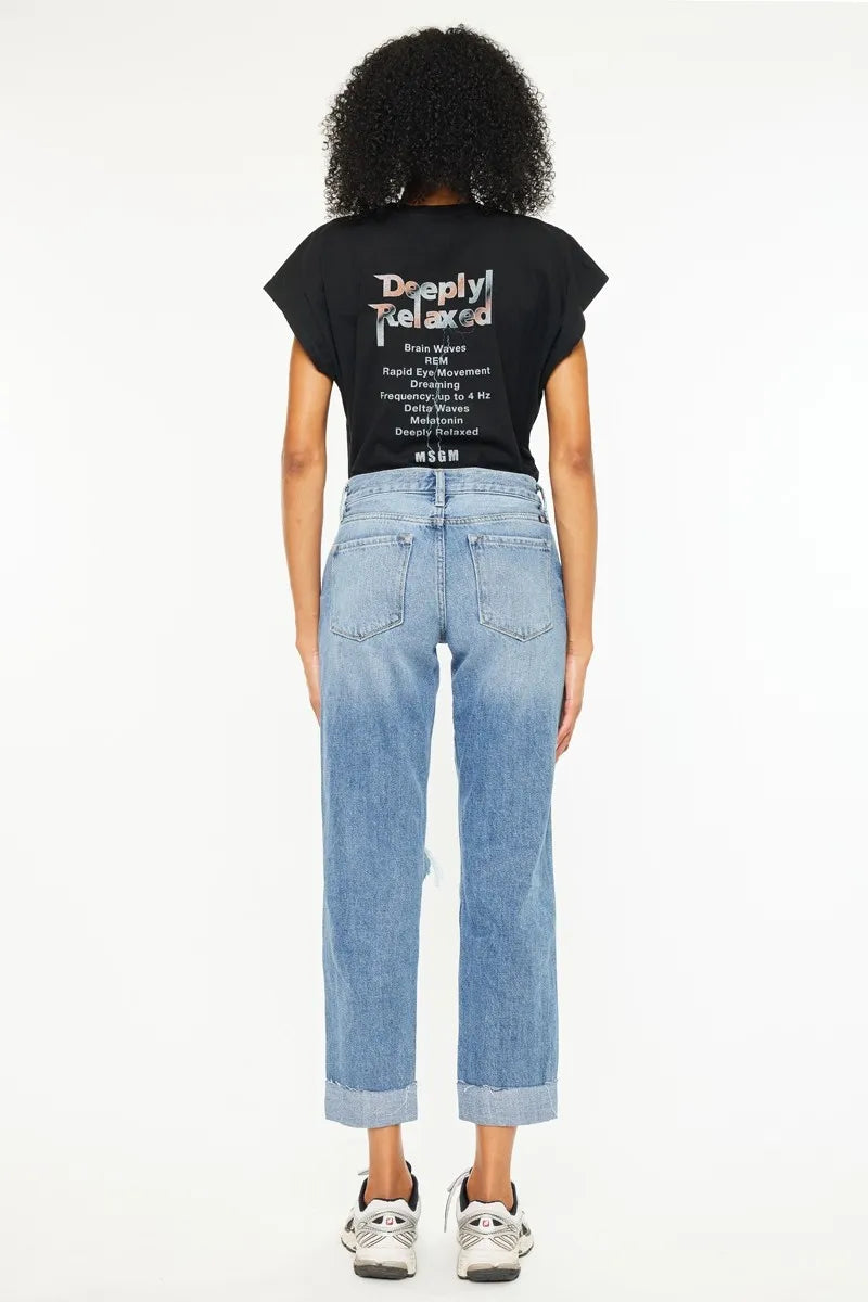 Back view: medium-wash mid-rise boyfriend jeans, straight legs, distressed hems