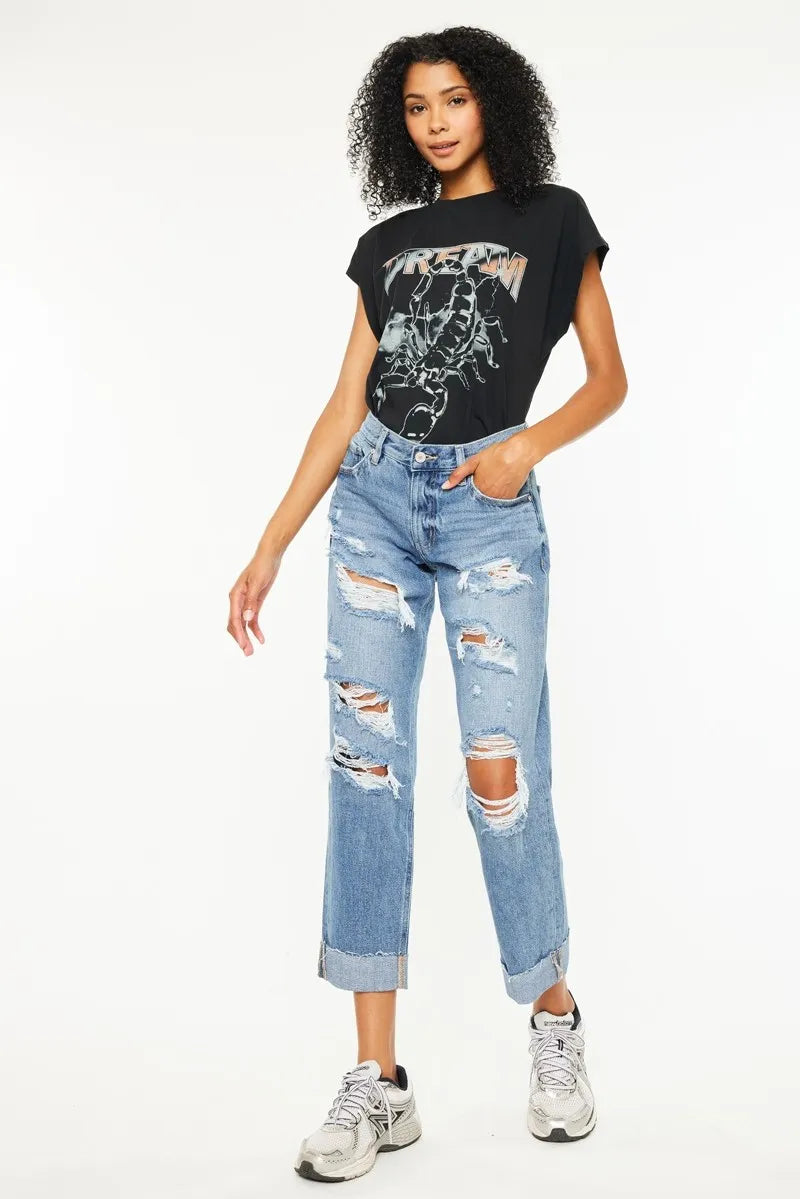Front view: distressed boyfriend jeans in medium wash, cropped straight legs