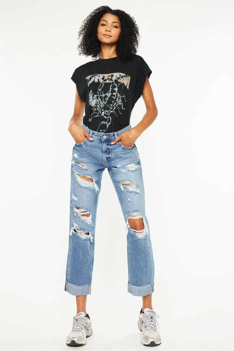 Medium-wash boyfriend jeans with multiple rips at knees and lightly frayed hems