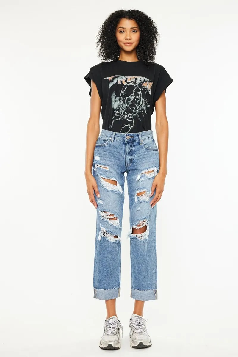 Medium-wash mid-rise boyfriend jeans, five-pocket style, distressed leg rips